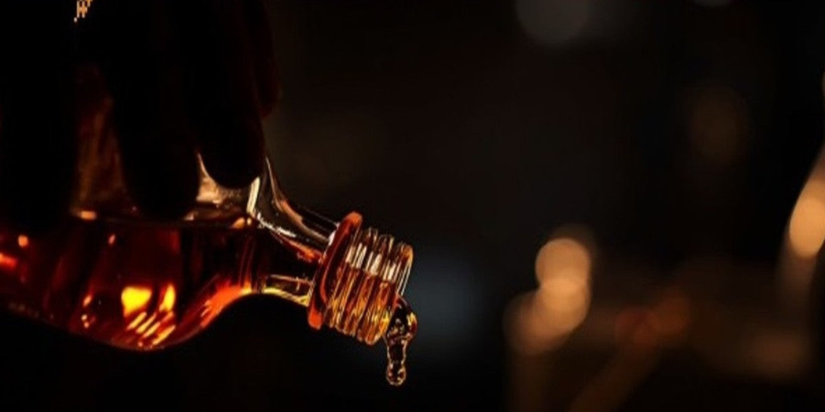 Hand-pouring fragrance into a decant vial